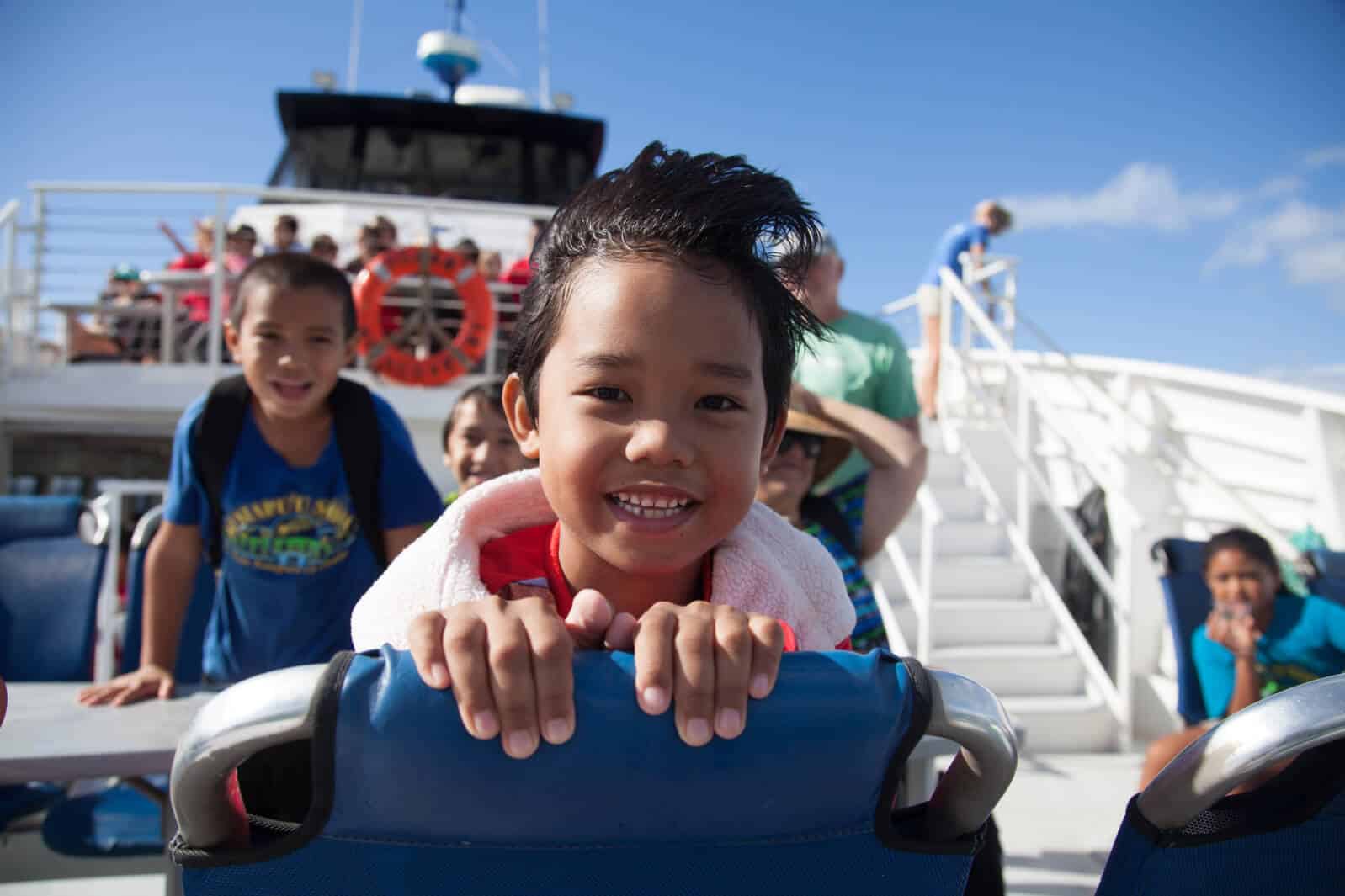 Child smiling while on a whalewatching field trip